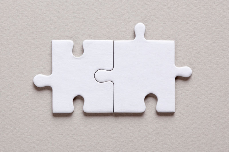 Image of puzzle pieces coming together